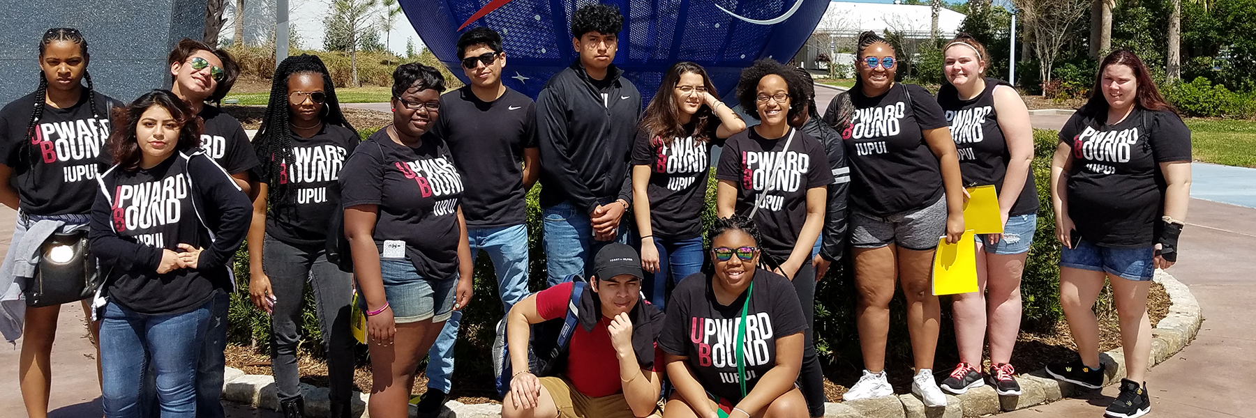 Upward Bound students in front of the NASA symbol.