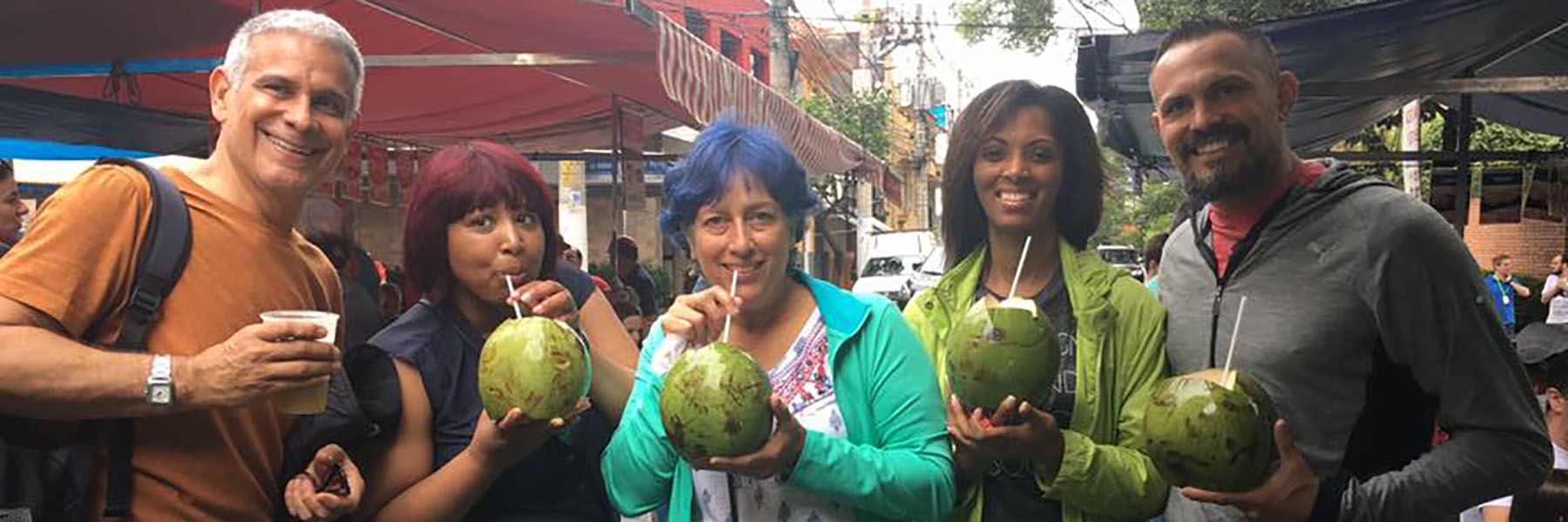 Upward Bound Director and others drinking coconut milk from a coconut.
